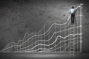 businessman drawing graphics on wall